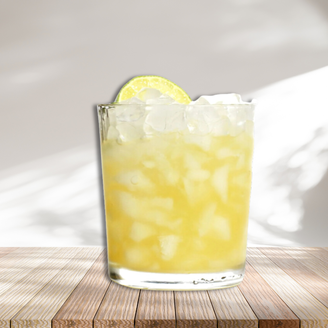 Yellow drink in old fashion glass with ice garnished with lemon sitting on wooden platform with white background