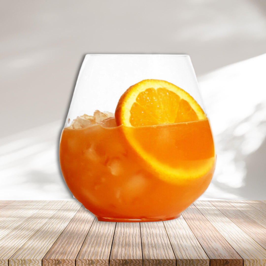 Orange drink in stemless wine glass with orange slice garnish in glass